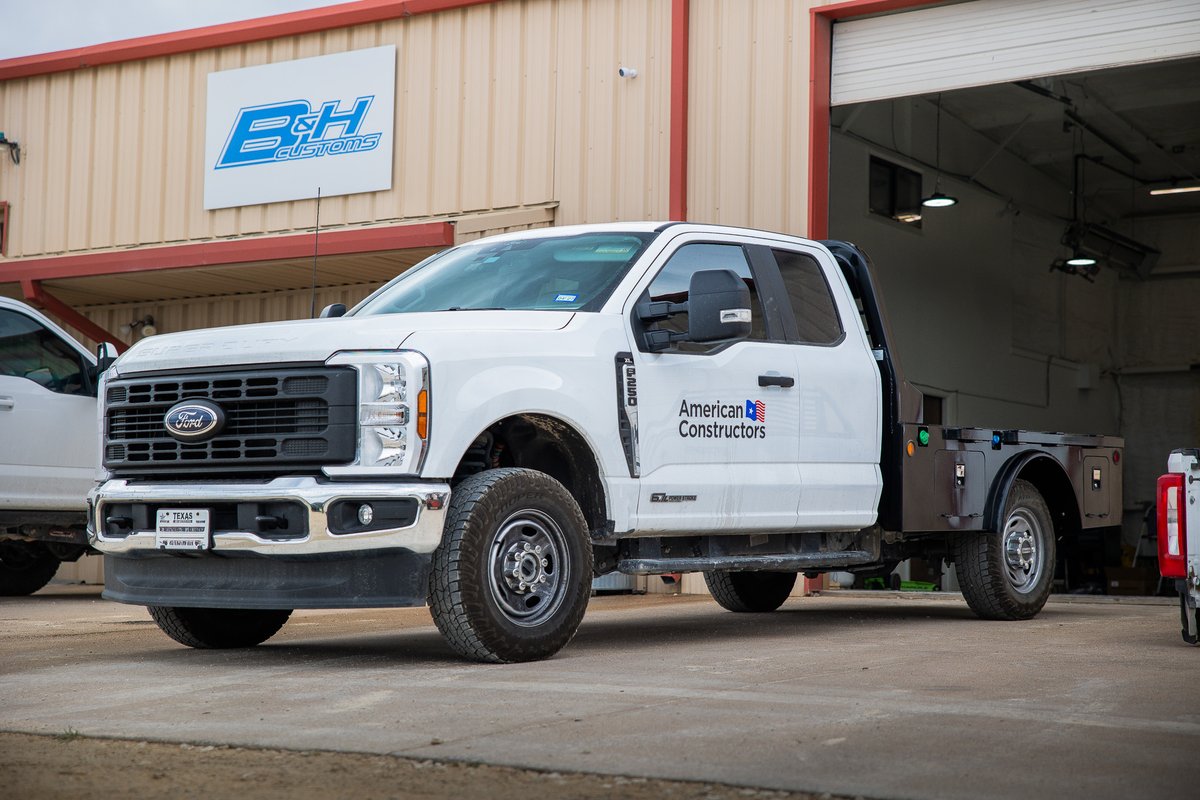 White Ford F-250 with American Constructors livery, chrome trim, and rugged rims.