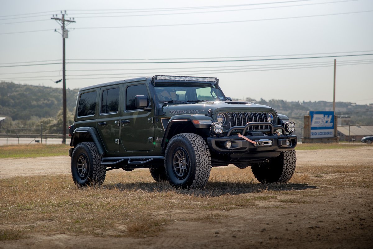 Olive green Jeep Wrangler 392 Rubicon with an LED light bar and aftermarket rims.
