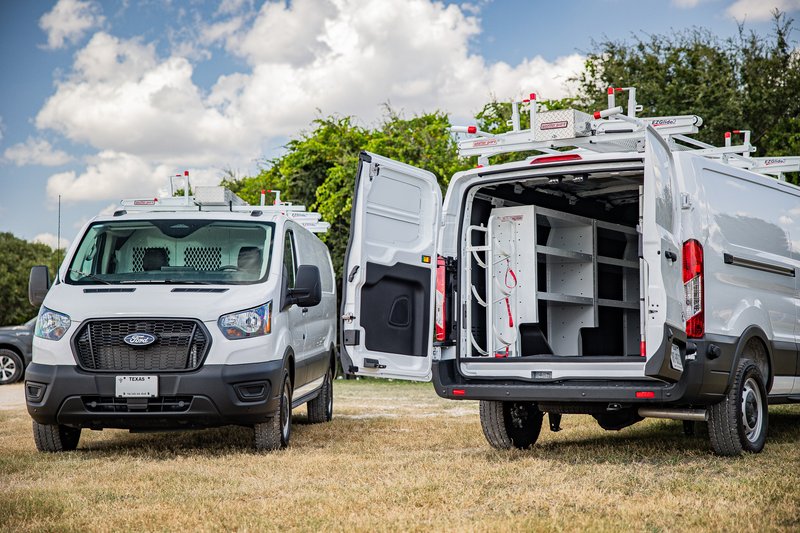 2026 Ford Transit van in white, outfitted with shelving and a ladder rack system.