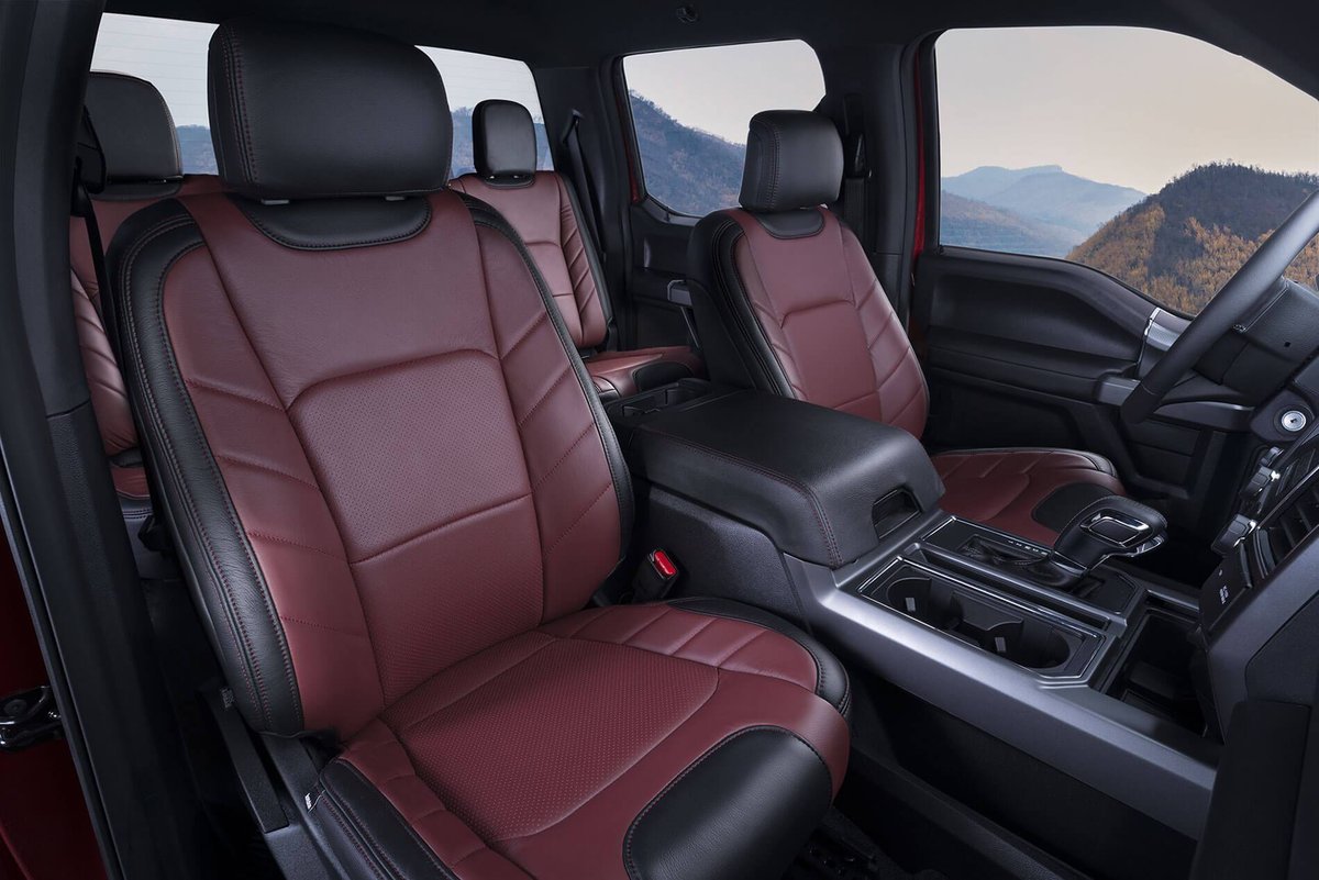 Ford F-150 Lariat Sport interior with two-tone red and black perforated leather front seats, center console and gear shifter
