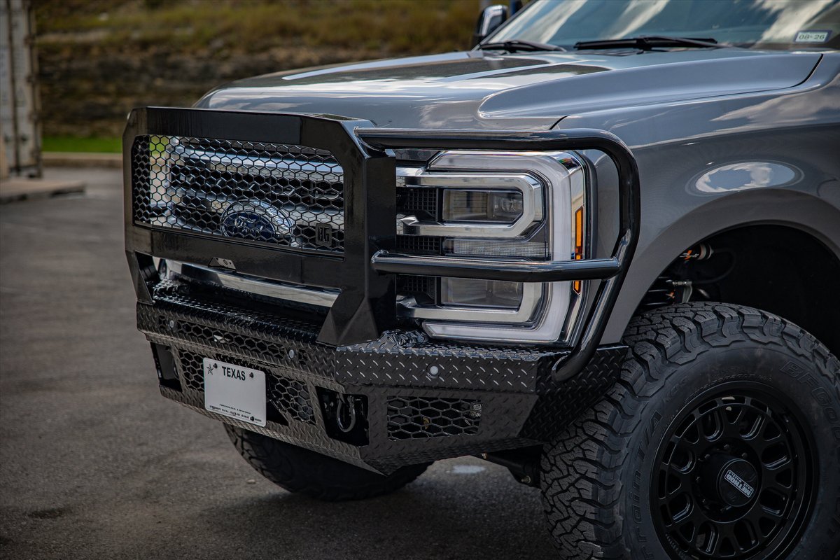 Gray Ford Super Duty truck with a heavy-duty front bumper and brush guard.