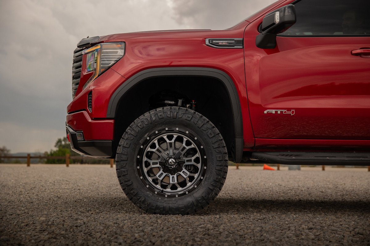 Red GMC Sierra AT4 with custom Fuel rims and tires.